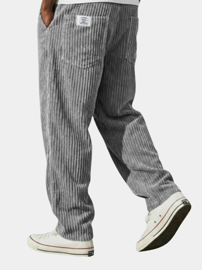 Wide-leg men's trousers with pockets in grey vertical cord texture.