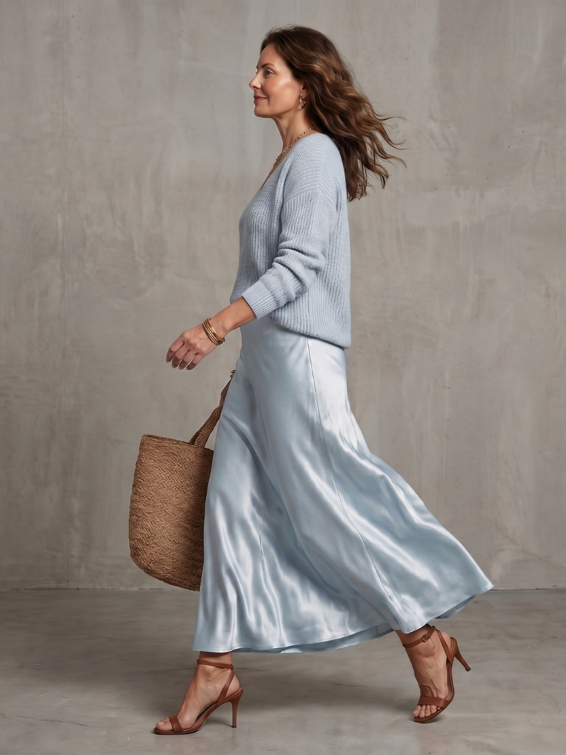 Women's sky blue knit sweater and satin bias skirt set, side view