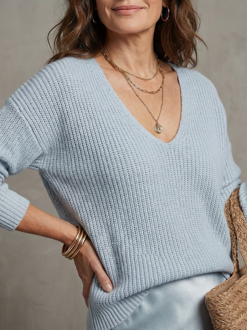 Women's sky blue knit V-neck sweater with satin bias skirt, close-up