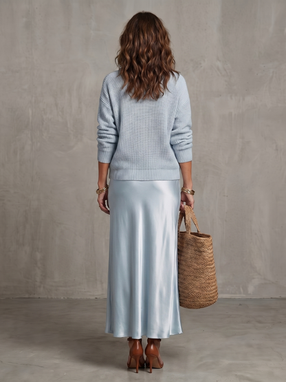 Women's sky blue knit sweater and satin bias skirt set, back view