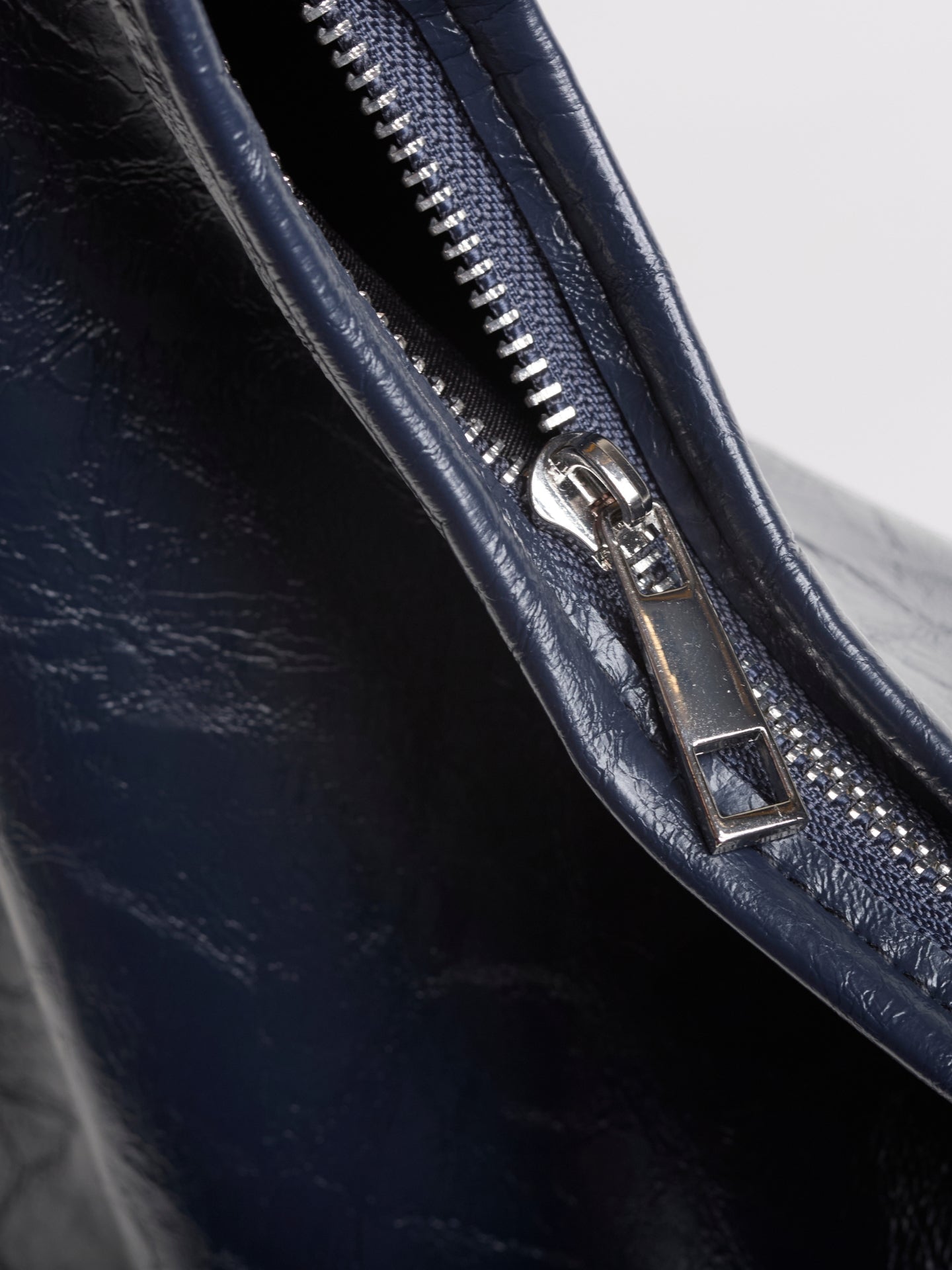 Navy distressed vegan leather tote zipper and stitching detail on curved seam