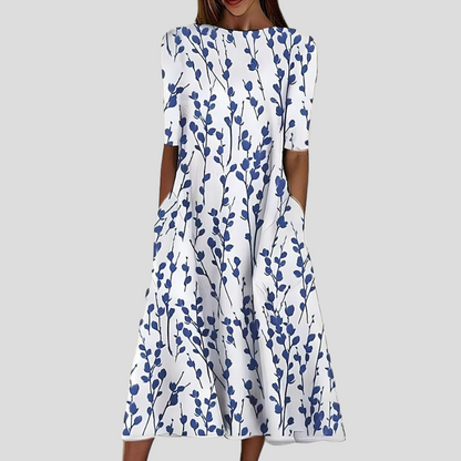 Floral midi dress in white with blue sprig print, round neckline and short sleeves