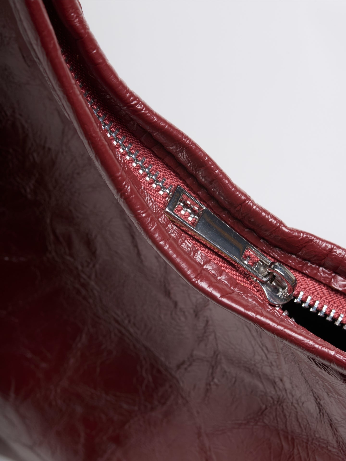 Red distressed vegan leather tote zipper detail and stitched trim