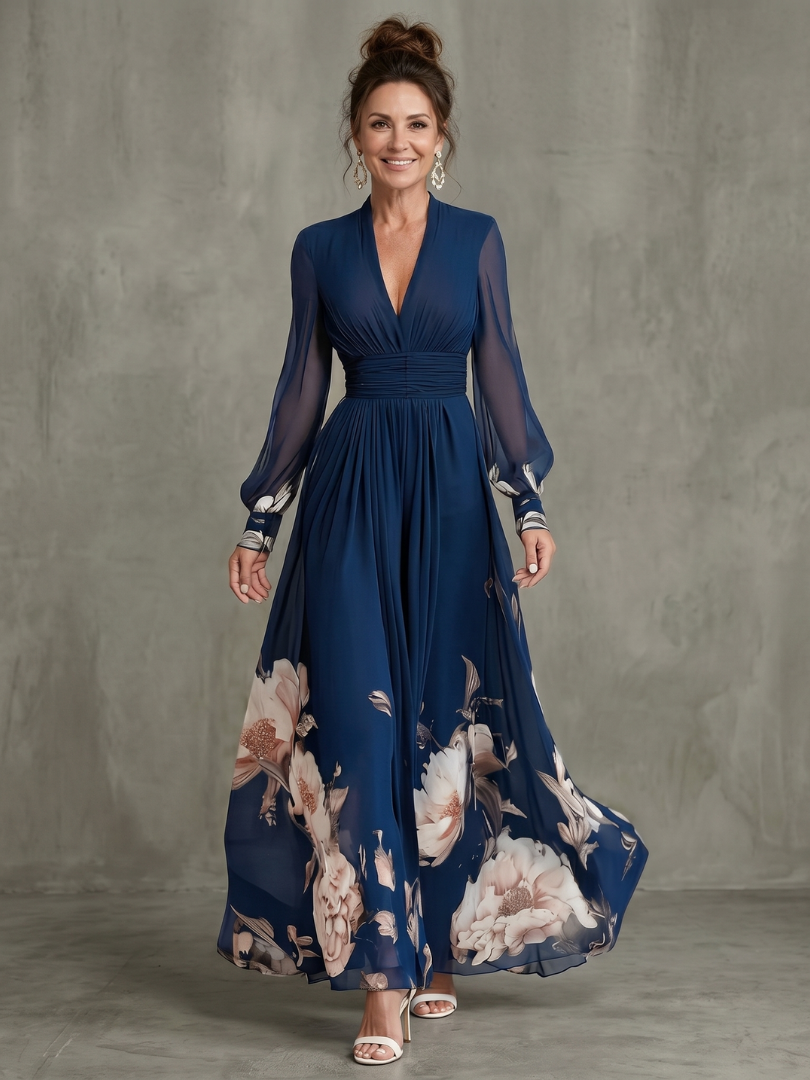 Navy maxi dress with pleated V-neck bodice, sheer pleated sleeves, floral print hem