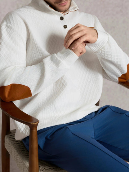 Cable-knit pullover sweatshirt in white with button placket and brown-edged cuffs