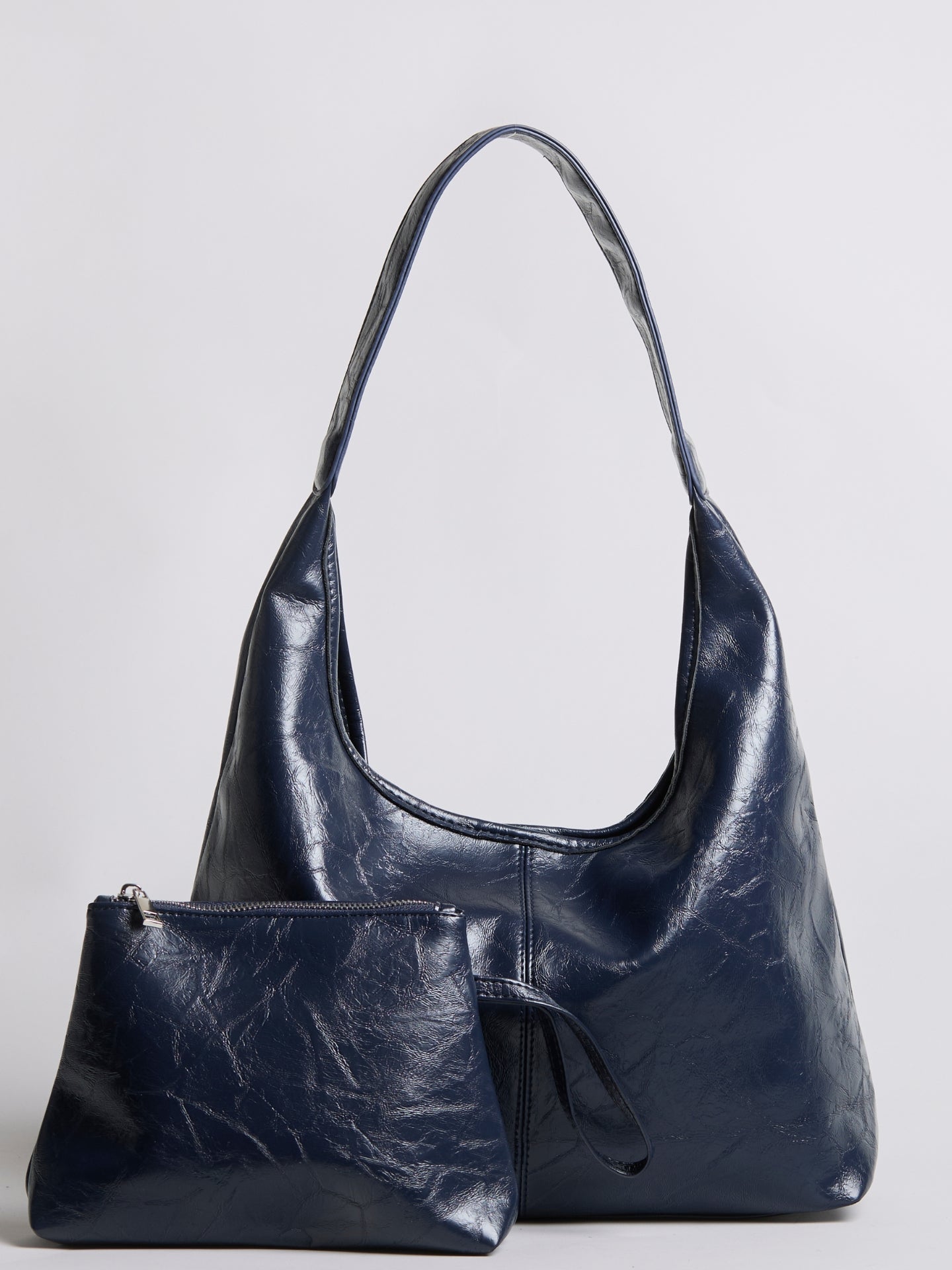 Navy distressed vegan leather hobo tote with matching zip pouch, short handles