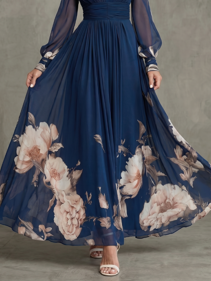 Navy pleated maxi skirt with large floral print hem and sheer sleeve cuffs