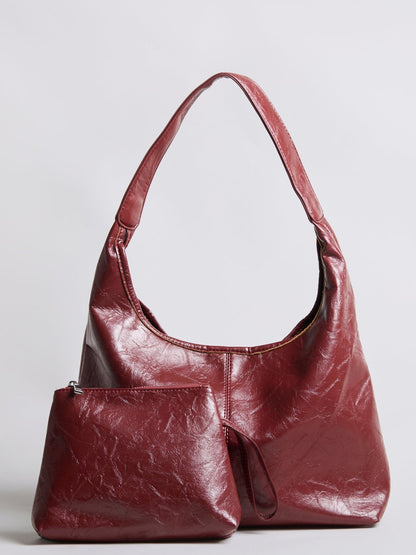 Burgundy distressed vegan leather hobo tote with attached mini pouch