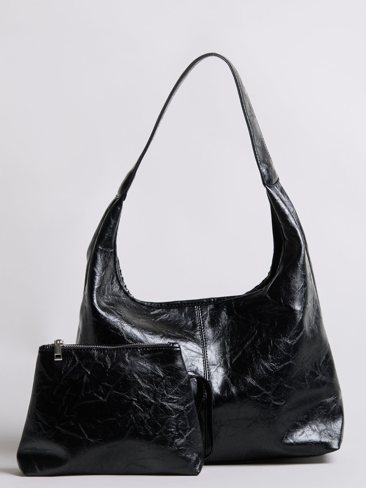 Distressed vegan leather tote bag in black with large top opening and side pocket