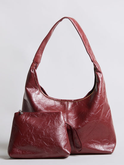 Burgundy distressed vegan leather tote bag with small zip pouch accessory