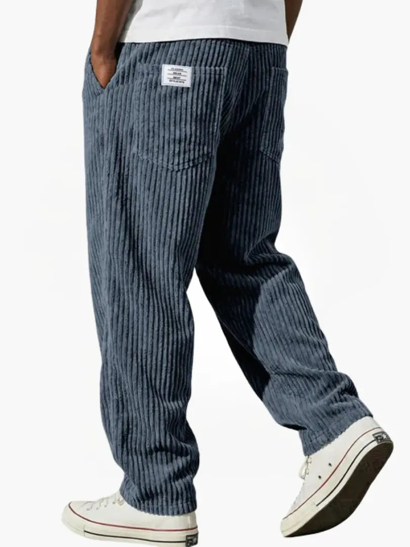 Wide-leg men's trousers with pockets in dark blue vertical cord texture.