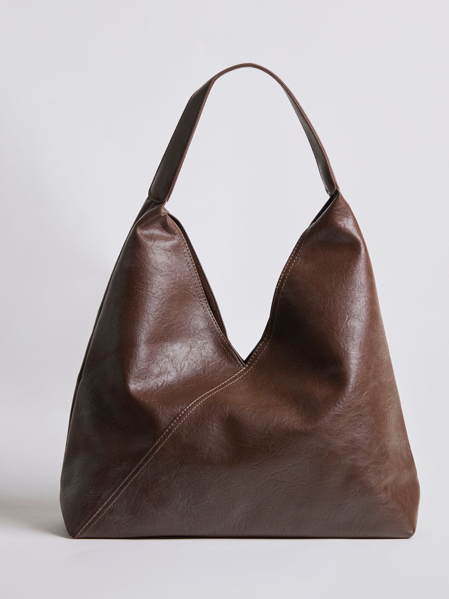 Brown leather shoulder bag with short top handles and V-shaped open front.