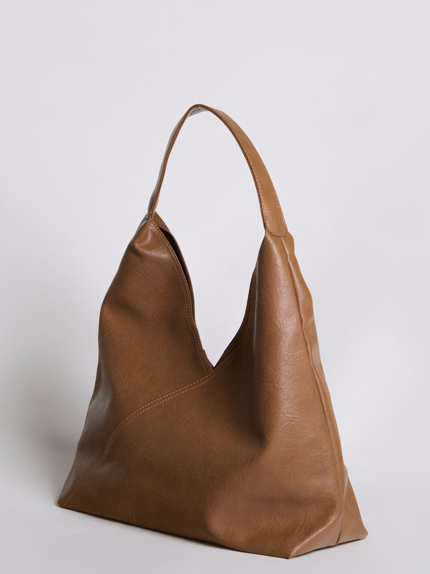 Brown leather shoulder bag with short handles and open V-shaped top.