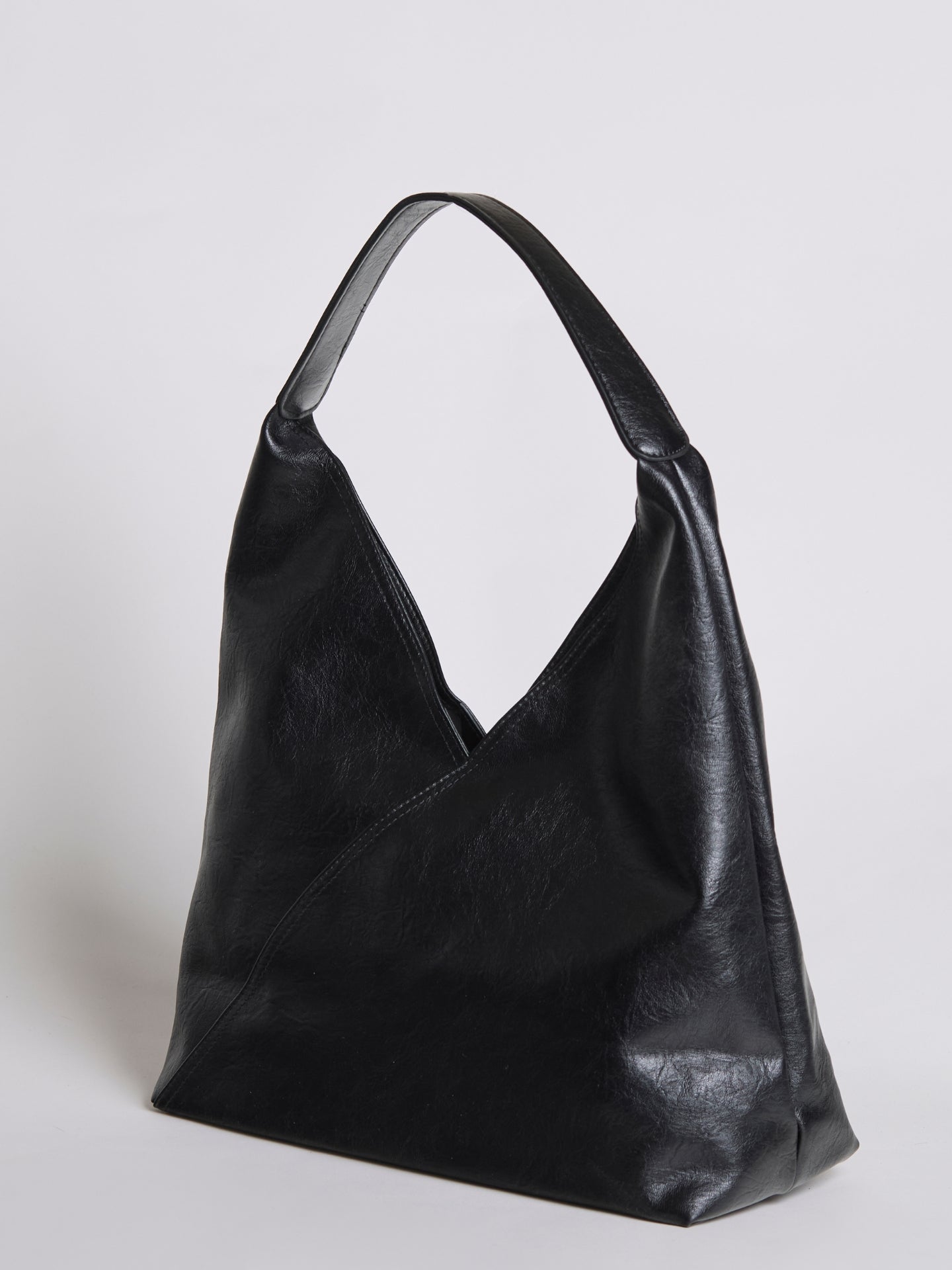 Black leather shoulder bag with short handles and slightly slouchy shape.