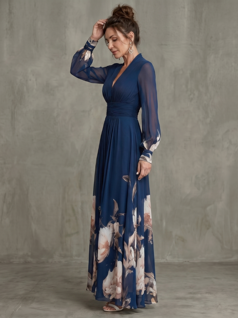 Navy pleated maxi dress with sheer sleeves and floral hem, ruched waist and V-neck