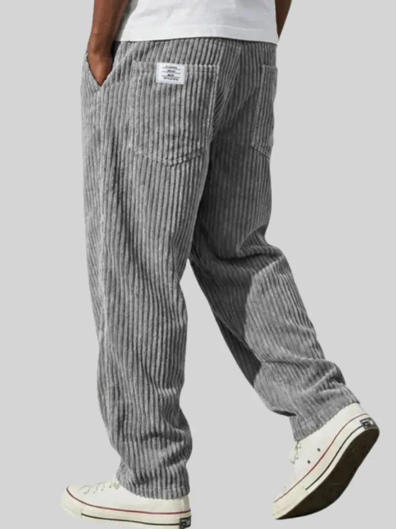 Wide-leg men's trousers with pockets in blue vertical cord texture.