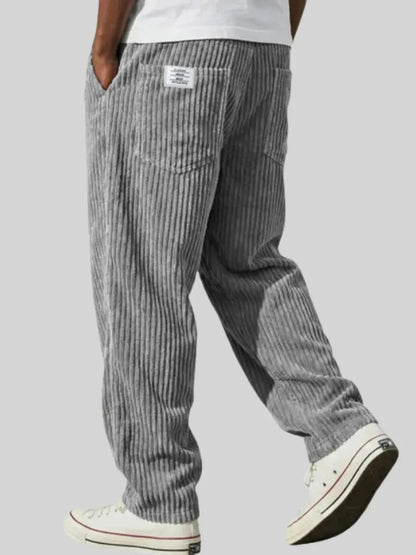 Wide-leg men's trousers with pockets in blue vertical cord texture.