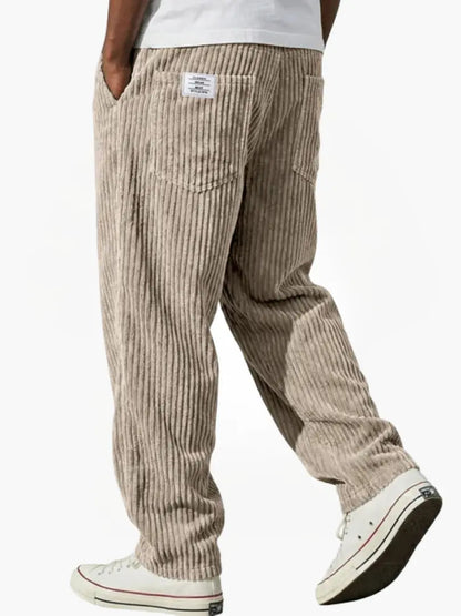 Wide-leg men's trousers with pockets in tan vertical cord texture.