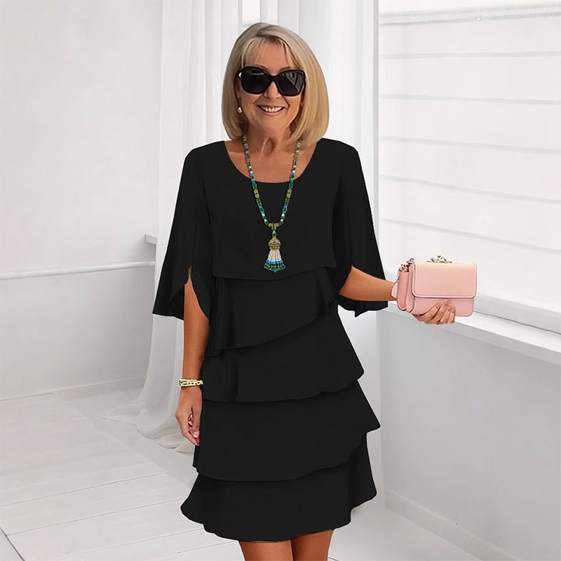 Black tiered puff sleeve dress with layered ruffle skirt and scoop neckline