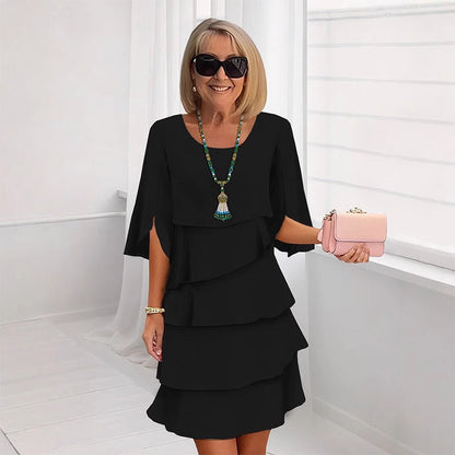 Black tiered puff sleeve dress with layered ruffle skirt and scoop neckline