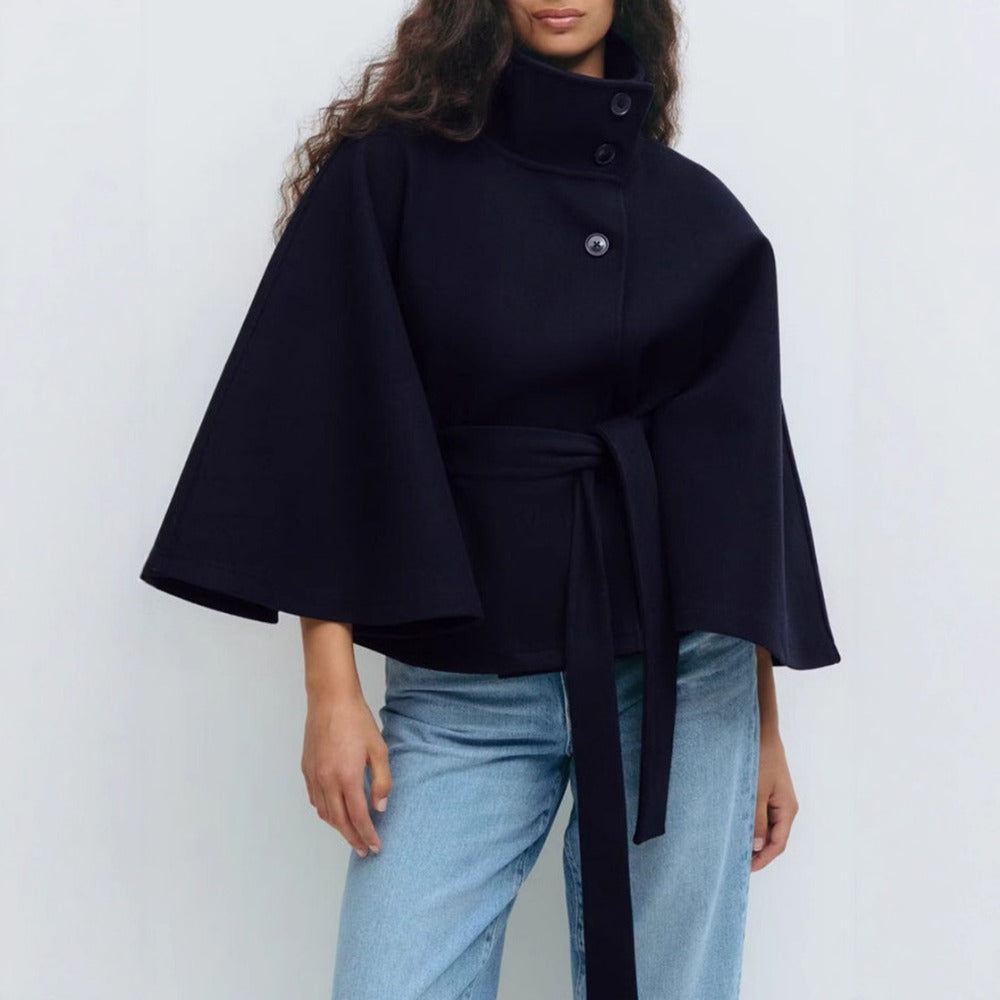 Women’s high-collar cape coat, dark navy, button front with waist tie and cape sleeves.