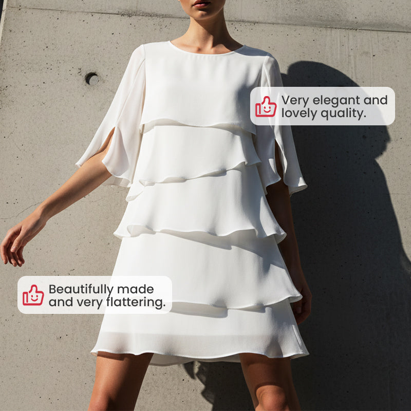 White tiered mini dress with flared ruffle sleeves