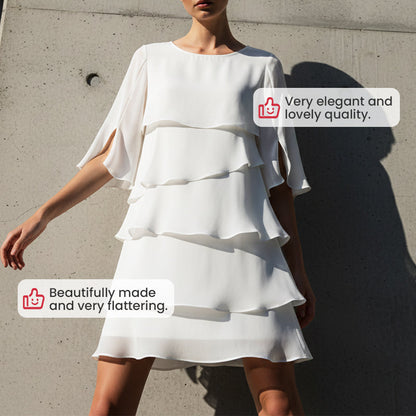 White tiered mini dress with flared ruffle sleeves