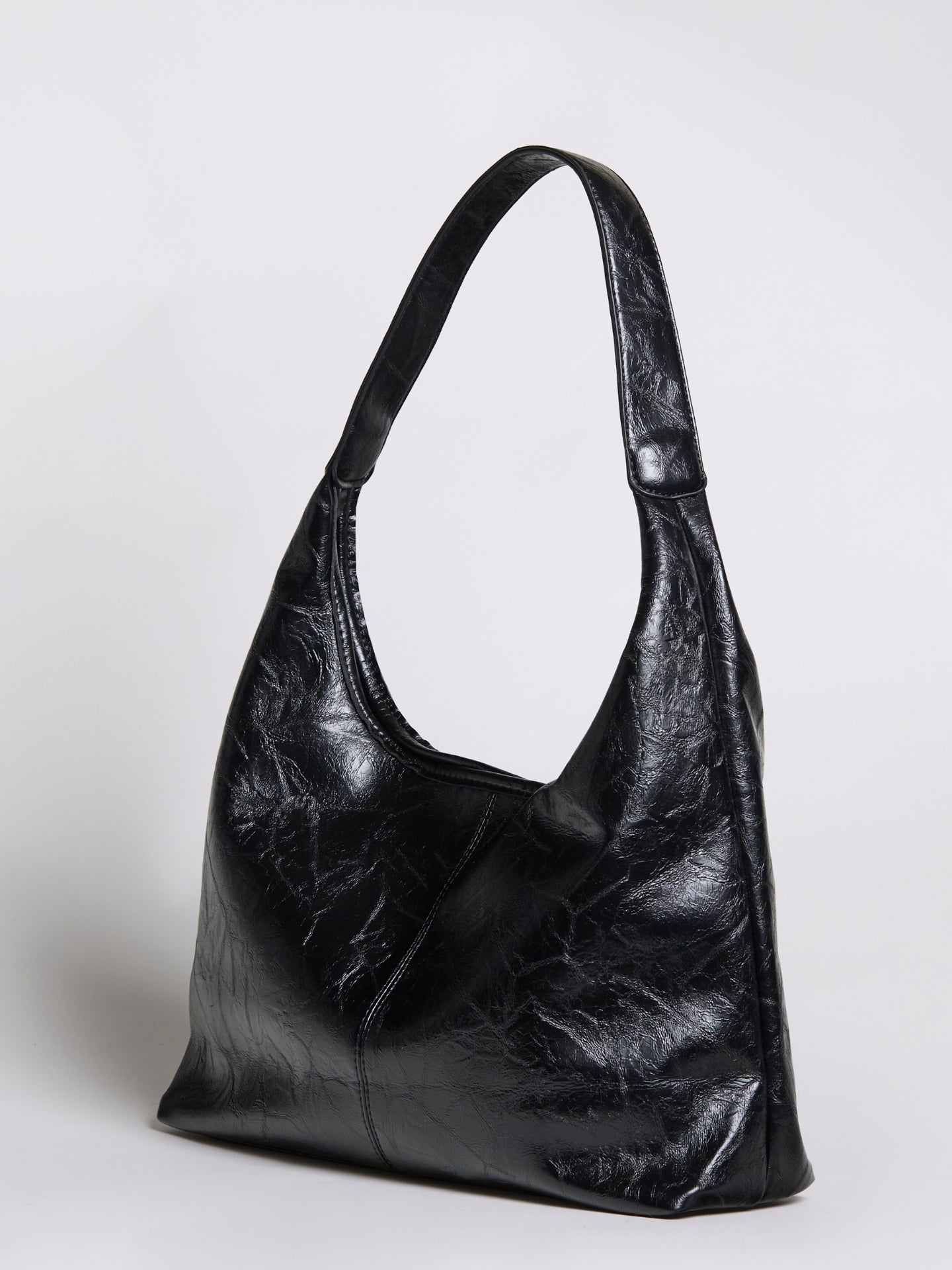 Black distressed vegan leather tote bag with curved handles and open top