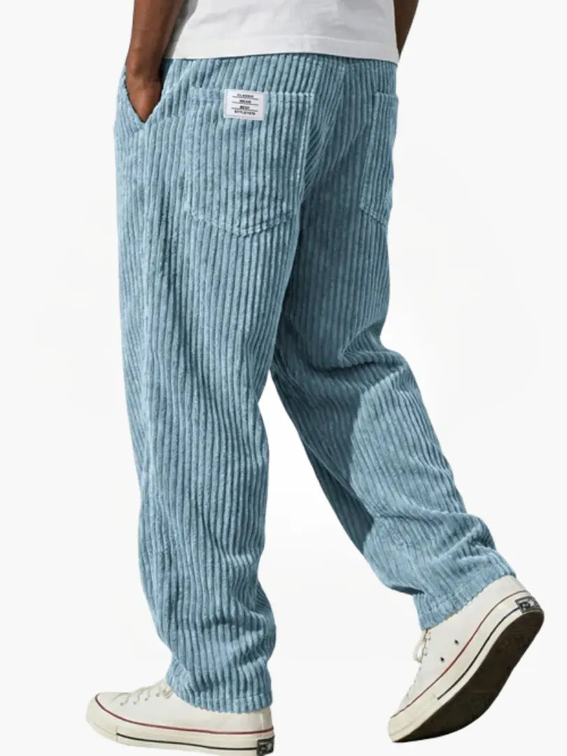 Wide-leg men's trousers with pockets in light blue vertical cord texture.
