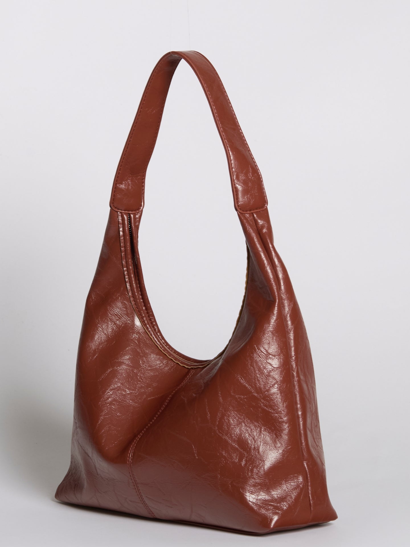 Distressed vegan leather tote bag in deep brown with wide shoulder straps