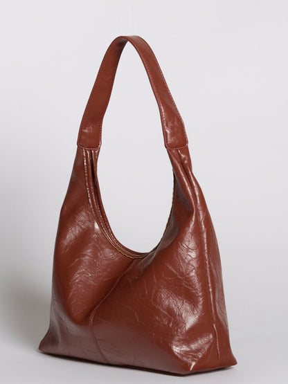 Distressed vegan leather tote bag in deep brown with wide shoulder straps