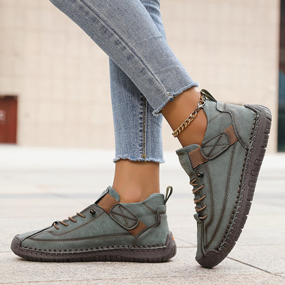 Gray slip-on trainers with lace-up front and ankle strap, worn with gold chain