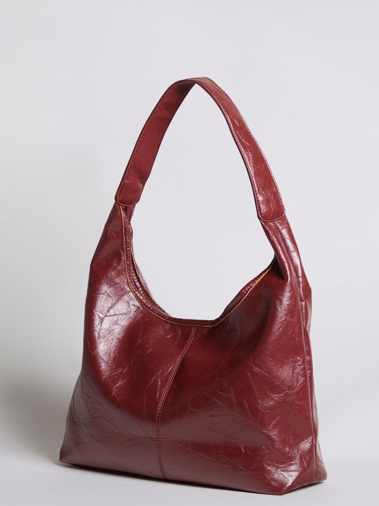 Burgundy distressed vegan leather tote with short handles and slouchy shape