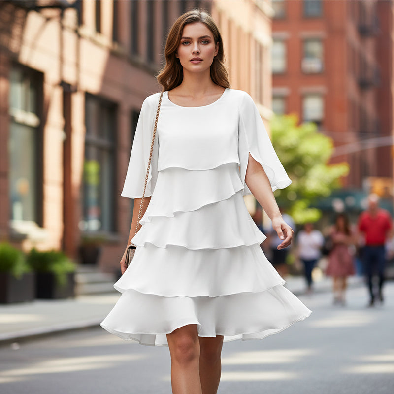 White tiered mini dress with short cape sleeves