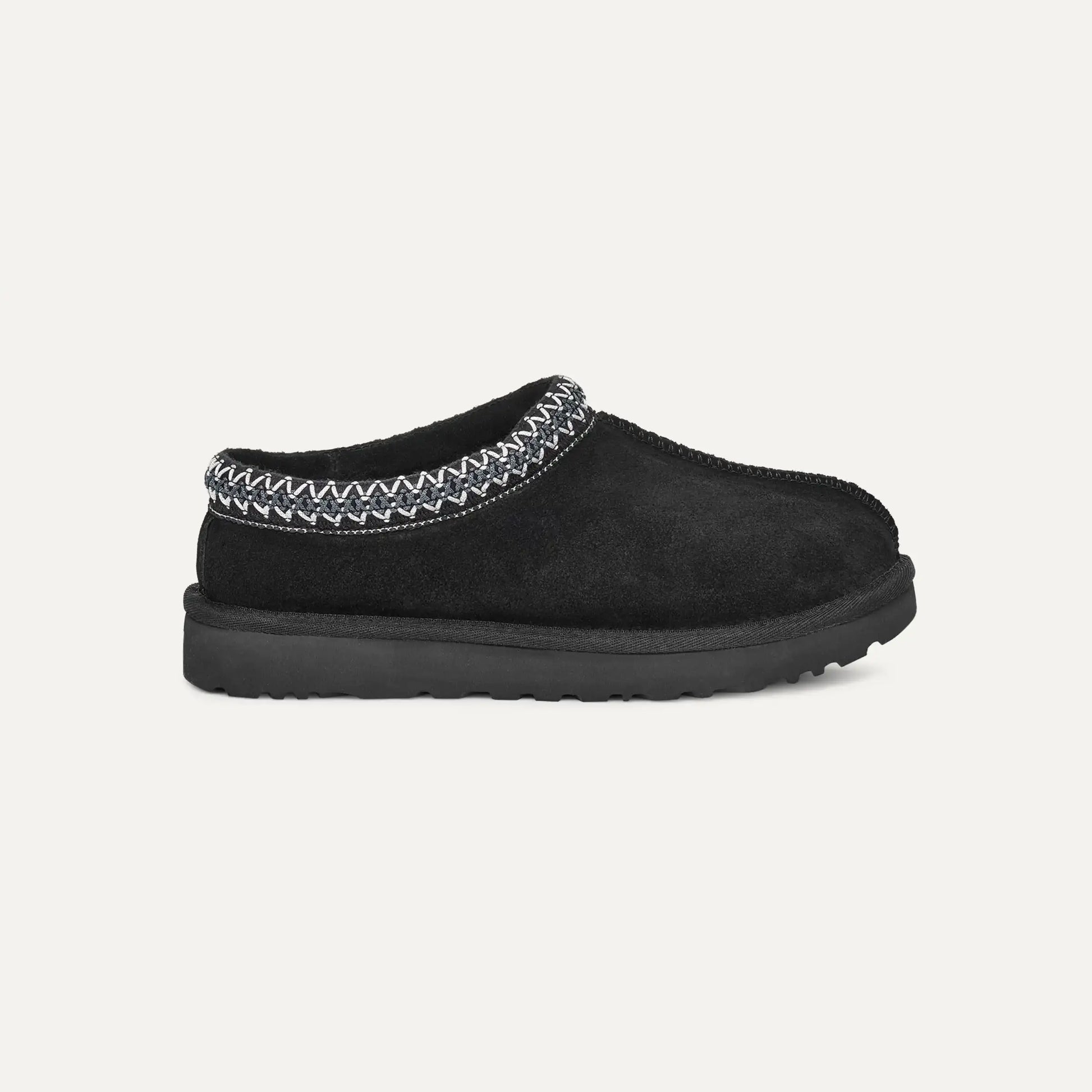 Suede slip-on slippers in black with braided trim and rubber sole