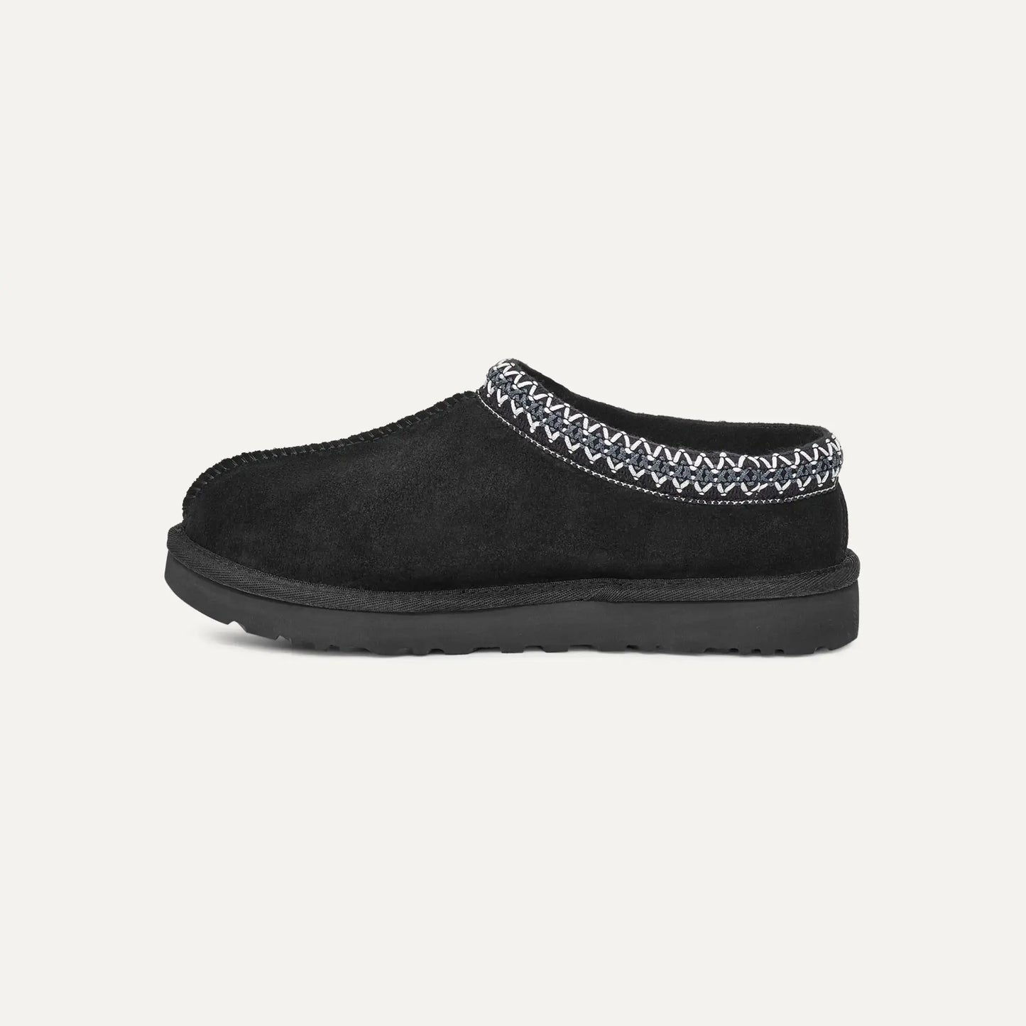 Black suede slipper with moc-style collar and stitched braided trim