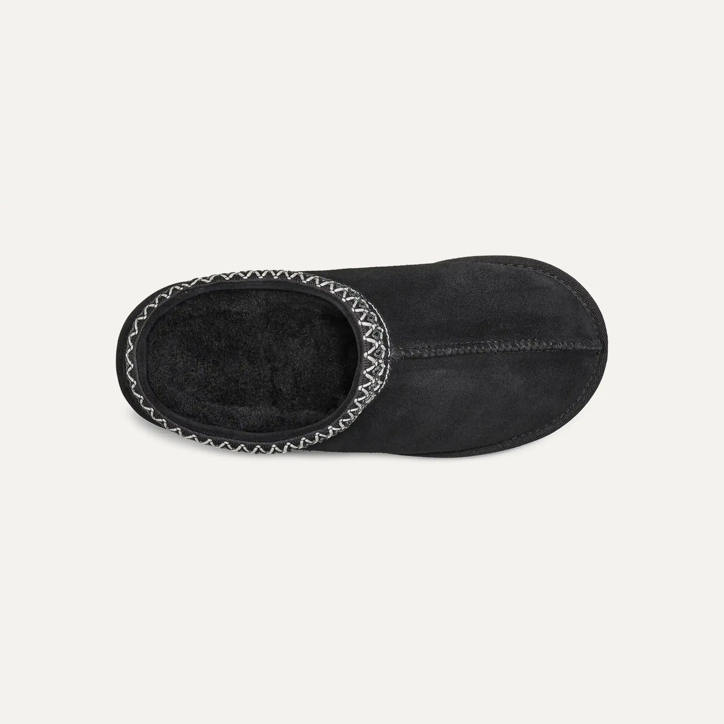 Black suede slip-on slipper with plush lining visible through opening