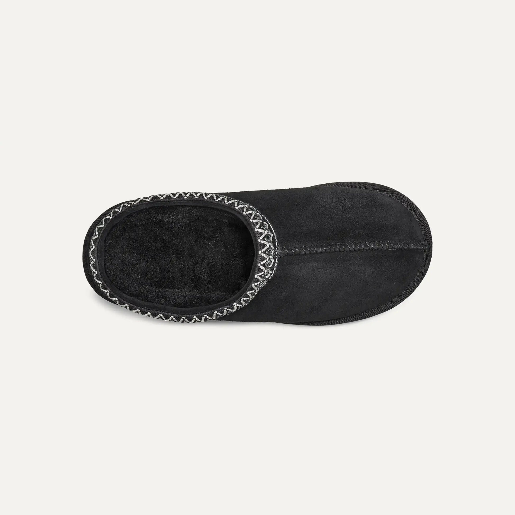 Black suede slip-on slipper with plush lining visible through opening