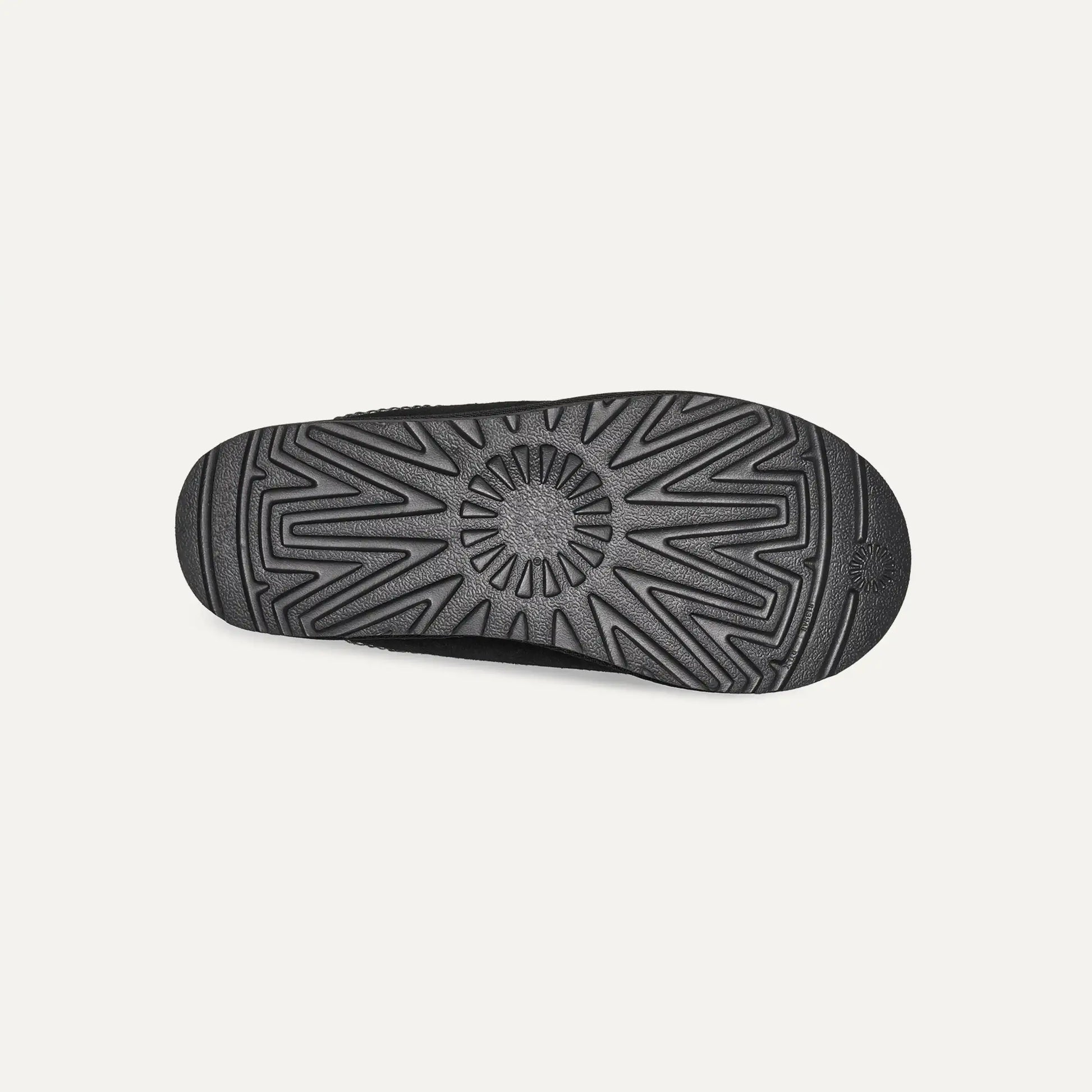 Black rubber outsole for suede slip-on slippers with geometric traction tread