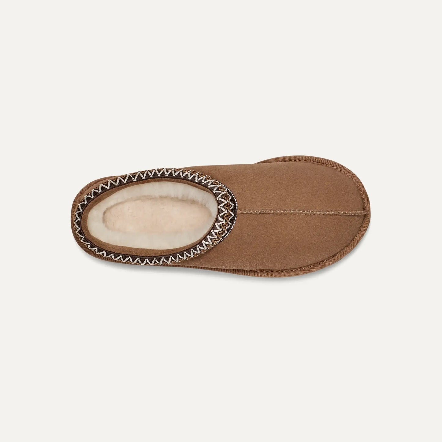 Chestnut brown suede slipper with plush lining and braided trim around opening