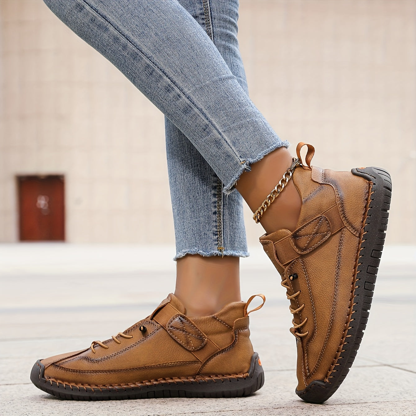 Tan slip-on trainers with lace-up front and ankle strap, cushioned tread sole