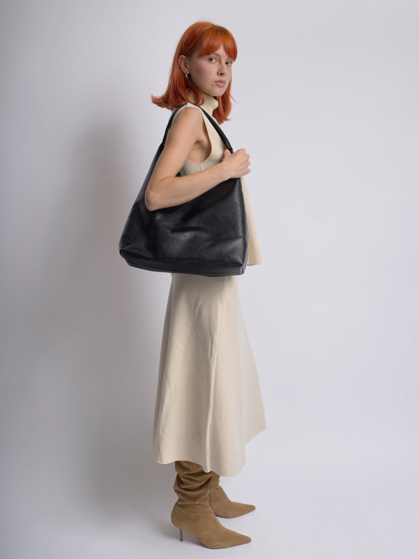 Black leather shoulder bag with soft slouchy shape and top handle straps