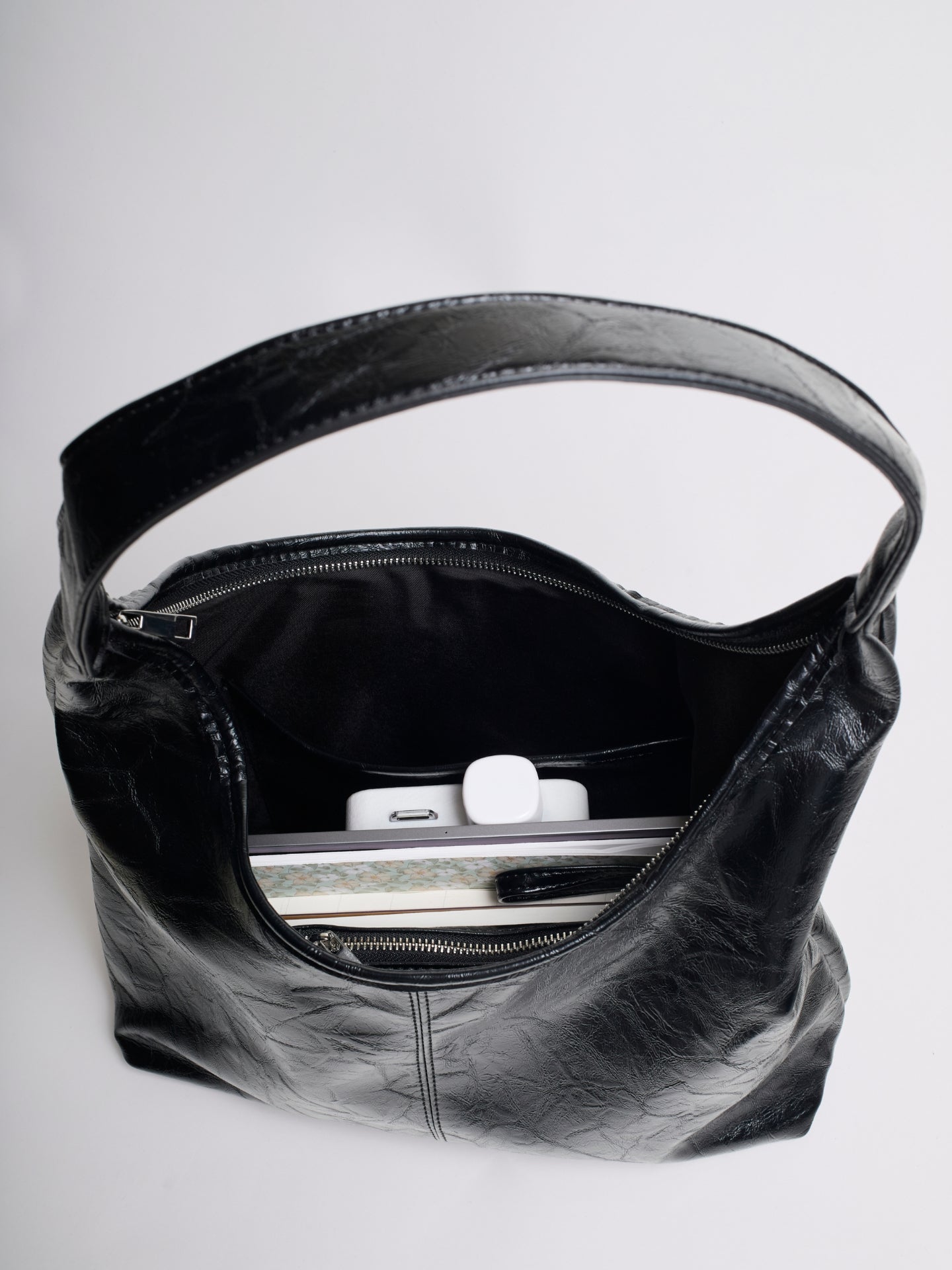 Distressed vegan leather tote bag interior view with black lining and zipper closure
