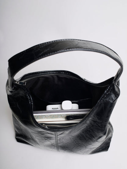 Distressed vegan leather tote bag interior view with black lining and zipper closure