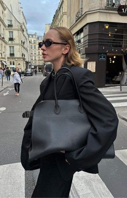 Matte black suede handbag with two top handles and wide side shape