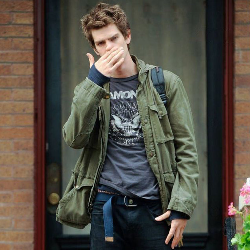 Men's olive green field jacket with hood folded back, worn over dark T-shirt