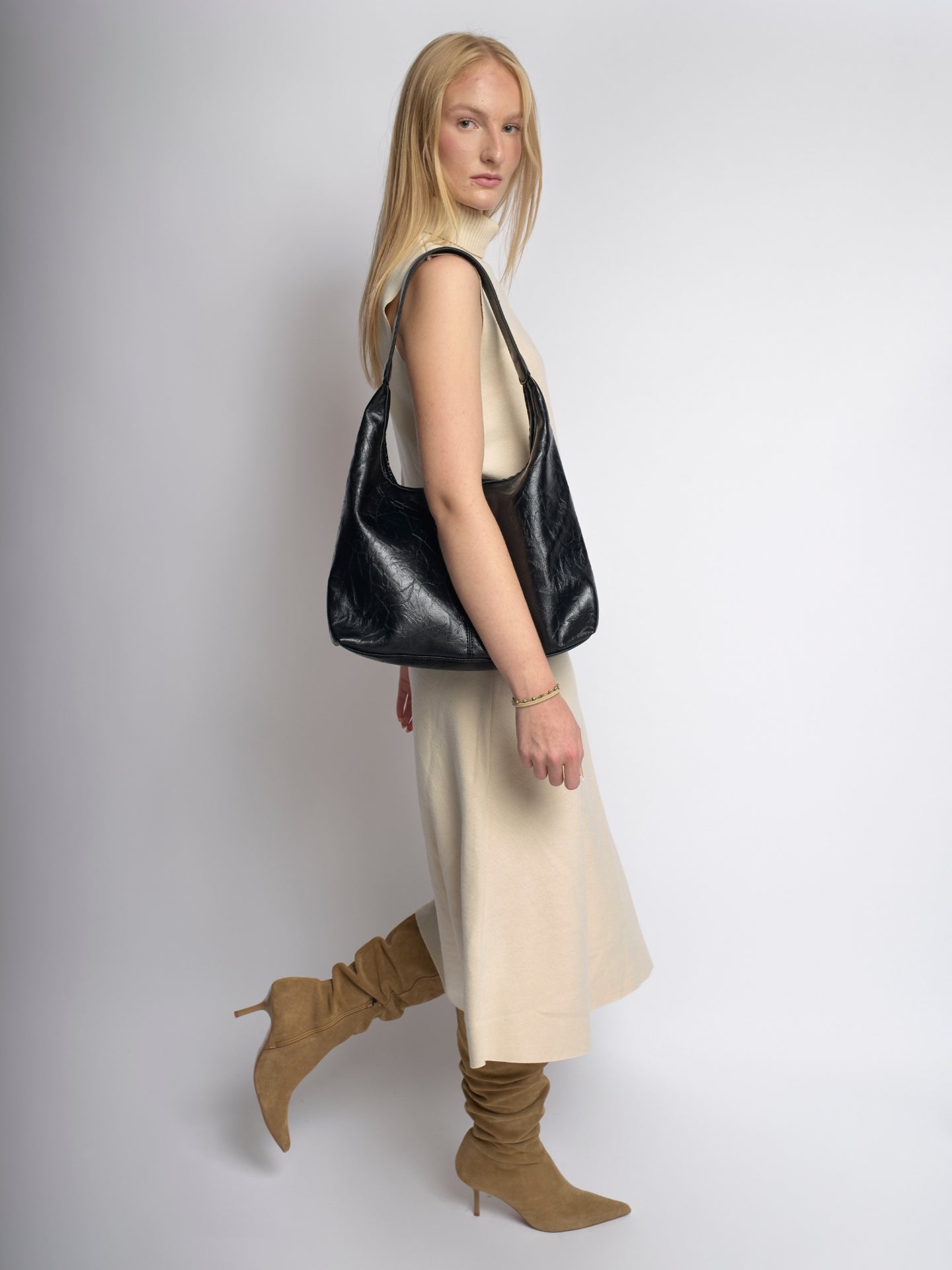 Black distressed vegan leather tote bag in side view with top handles