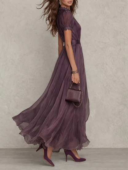 Women's plum maxi dress with high neck, puff sleeves, pleated tulle skirt (side view)