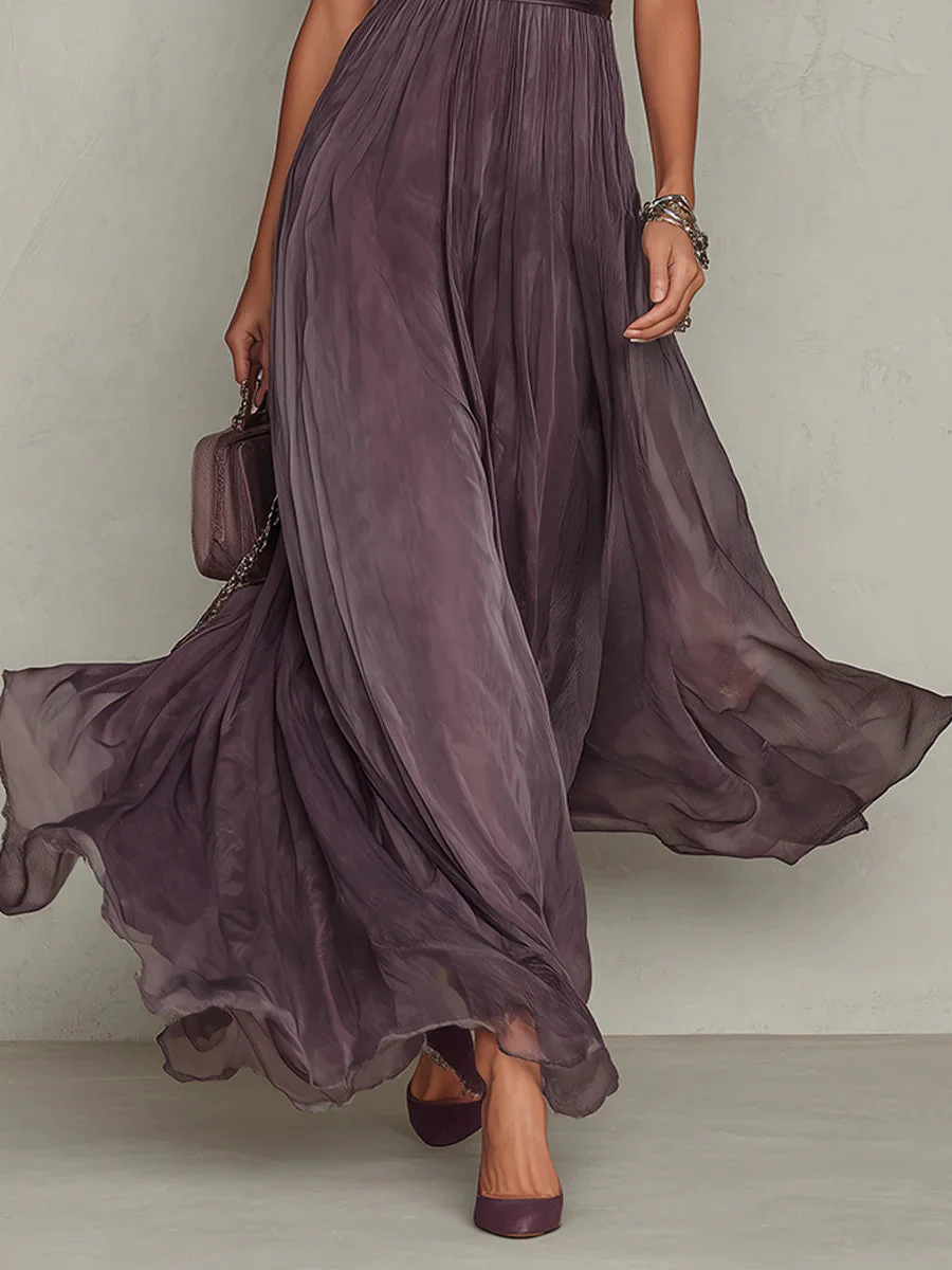Women's plum maxi dress with pleated tulle skirt and puff sleeves (walking side view)