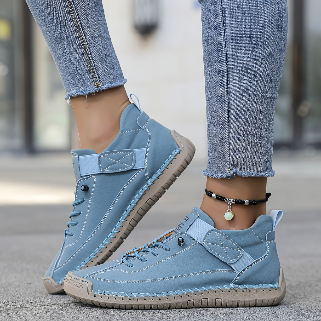 Light blue slip-on trainers with lace-up front and ankle strap, stitched rubber sole